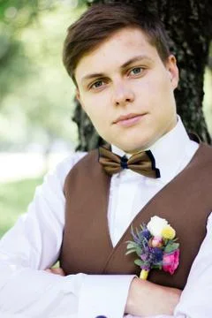 Portrait of elegant groom on wedding ceremony. Groom hairstyle. Stock Photos