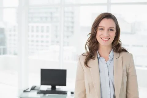 Portrait of an elegant smiling businesswoman in office Stock Photos