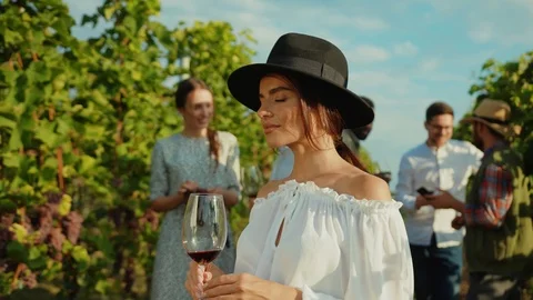 Portrait of elegant young lady in hat toasting with wineglass smiling cheerfully Stock Footage 117255486