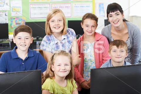 Portrait Of Elementary School Pupils With Teacher In Computer Class Stock Photos