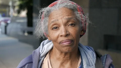 Portrait of emotional African American homeless woman looking in camera dejected Stock Footage