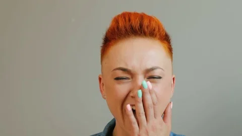 Portrait of emotionallaughing woman with short red hair laughing at the camera Stock Footage