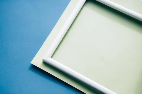 Portrait empty frame mockup on blue background Stock Photos
