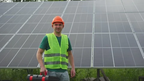 Portrait of an engineer against a background of solar panels. Stock Footage 314462343