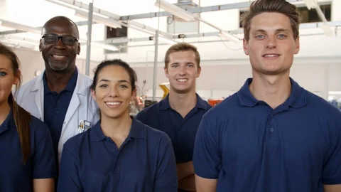 Portrait Of Engineer With Apprentice Students In Workshop Stock Footage 86600909