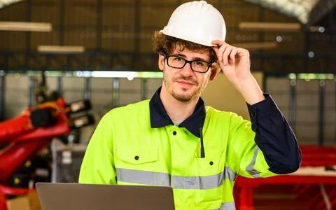 Portrait of engineer checking and inspecting machine at industrial factory Foto stock