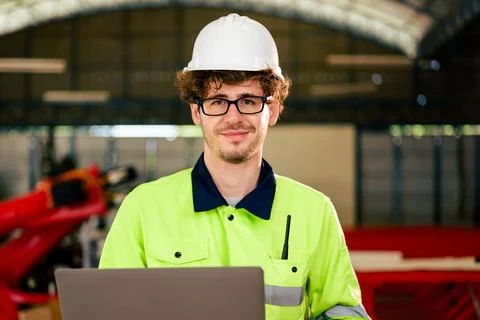 Portrait of engineer checking and inspecting machine at industrial factory Foto stock