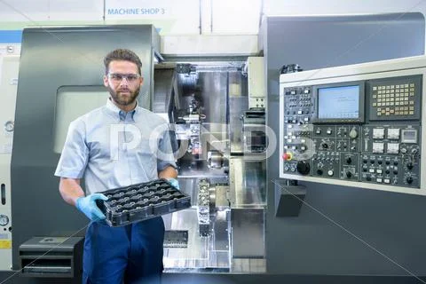 Portrait Of Engineer With Cnc Lathe In Automotive Parts Factory