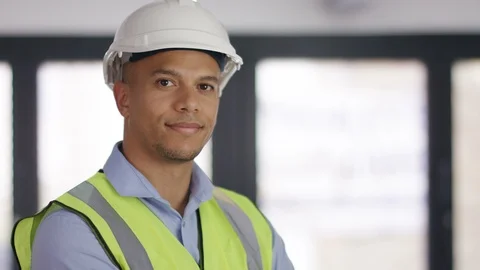 Portrait of engineer in hard hat looking to camera, in slow motion 96333813