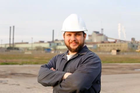 Portrait of engineer in helmet standing in construction site background. 스톡 사진