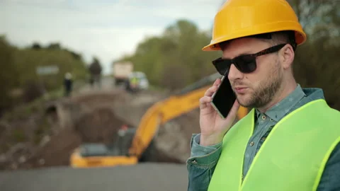 Portrait of an engineer to make a call for business discussion while a document Stock Footage 160591557