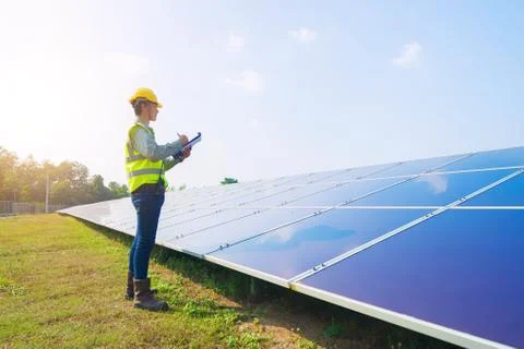 Portrait of engineer man or worker, people, with solar panels or solar cells  Stock Photos