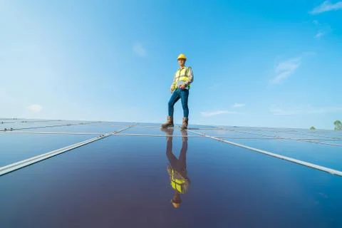 Portrait of engineer man or worker, people, with solar panels or solar cells  Stock Photos
