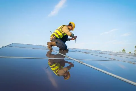 Portrait of engineer man or worker, people, with solar panels or solar cells  Foto stock