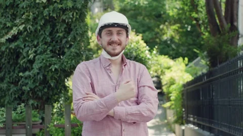 Portrait of an engineer man wearing a protective medical mask and helmet. Stock Footage 135848474