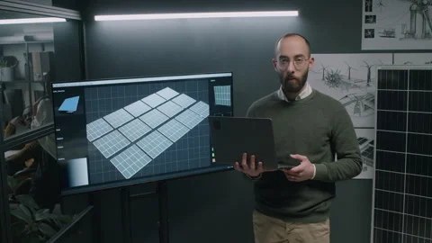 Portrait of Engineer Posing with Laptop near Screen with Solar Panels Stock Footage 270536891
