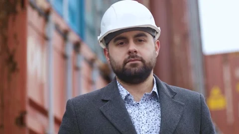 Portrait of engineer with safety helmet on container platform for export Stock Footage 306217439