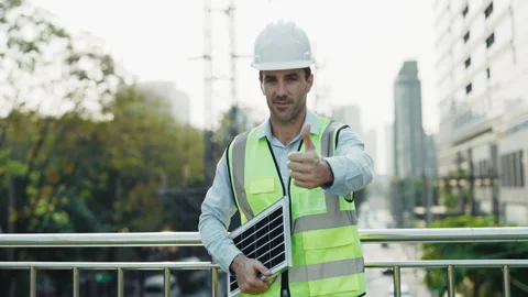 Portrait of engineer showing thumbs up holding solar panel Stock Footage 304705099