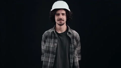 The portrait of the engineer with the white helmet looking at the camera and Stock-Footage 156277675