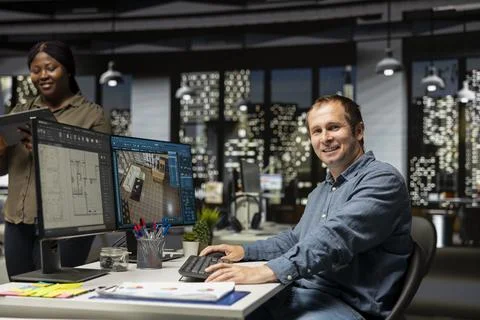 Portrait of engineer working on floor plan interior design at computer Stock Photos