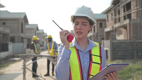 Portrait of engineers work together to assess the residential Stock Footage 308929434