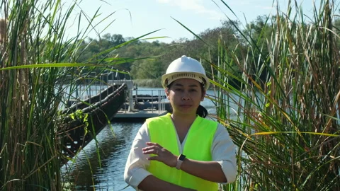 Portrait of environmental engineer wearing white helmet working at reservoir. Stock Footage 229708177