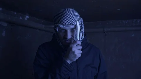 Portrait of an evil terrorist with a knife in his hands Video stock 82541095