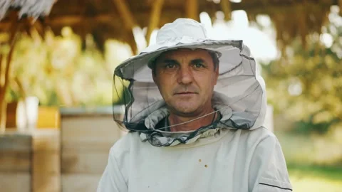 Portrait of an experienced cheerful beekeeper in protective gear. Stock Footage 226887551