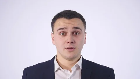 Portrait of an expressive young man in suit on isolated background Stock Footage 73630153