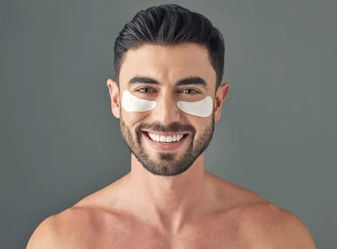 Portrait, eye patch and man in studio with skincare, cosmetics and dermatology 스톡 사진