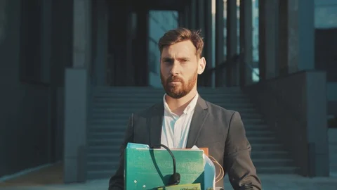 Portrait face handsome young man stand look at camera with box of personal stuff Video stock 129463627