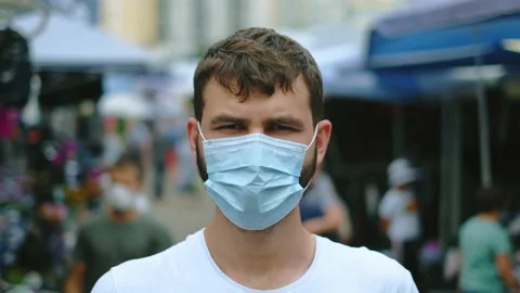 Portrait of facemask guy standing on asian market during coronavirus pandemic. Stock Footage 160920342