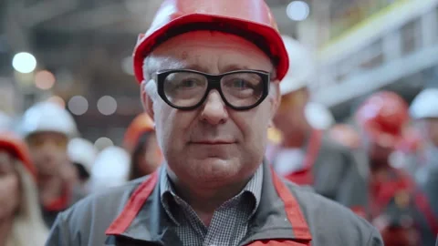 Portrait of a factory worker in front of a crowd of workers. Stock Footage 196174180