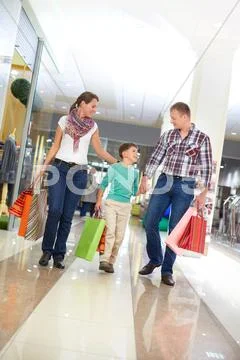 Portrait of family with paperbags walking in the mall Stock Photos