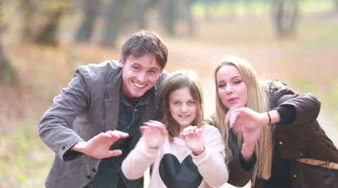 Portrait of family waving in park Stock Footage 59554278