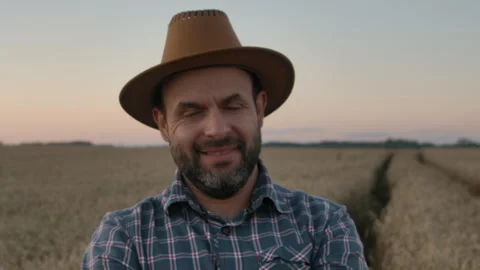 Portrait Farmer Bearded Man With Hat Standing in Wheat Field. Farm Worker Stock Footage 252204397