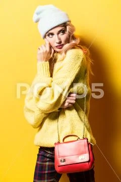 A portrait of a fashionable bright lady posing in studio. Fashion for women. Stock Photos