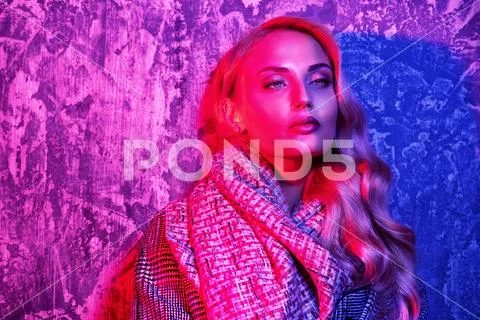 A portrait of a fashionable bright lady posing in studio. Fashion for women. Stock Photos
