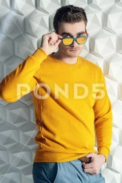 A portrait of a fashionable young man posing in the studio. Casual fashion fo Stock Photos