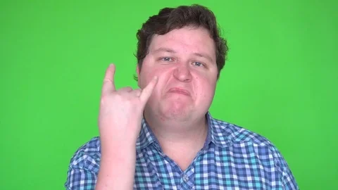 Portrait of fat man rocker gesturing with hand and looking at camera against Stock Footage 83601096
