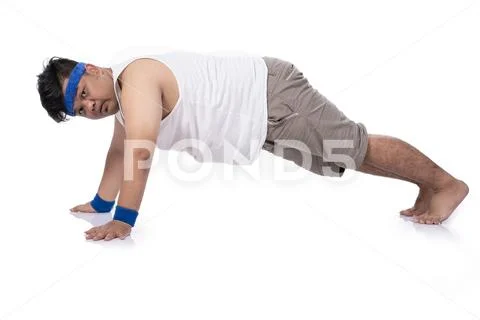 Portrait of fat young man try harder doing push up Stock Photos