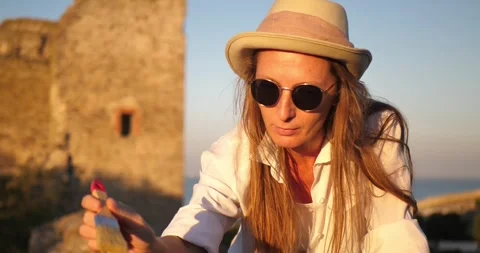 Portrait of a female archaeologist cleaning an object with a brush against the Stock Footage 290851972