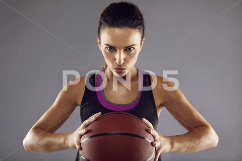 Portrait of female basketball player in studio Stock Photos