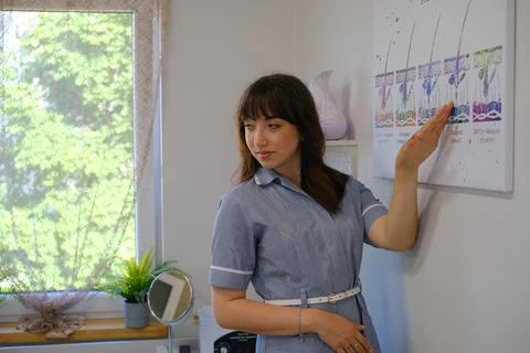 Portrait of female dermatologist explaining to client about electrolysis. E.. Stock-Fotos