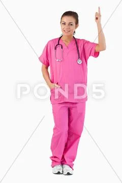 Portrait of a female doctor pointing at a copy space Stock Photos
