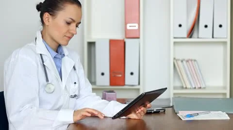 Portrait of female doctor with tablet computer in her office Stock Footage 8852811