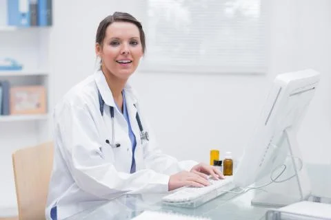 Portrait of female doctor using computer at clinic Foto stock