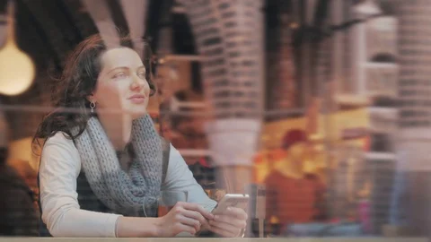 Portrait of female drinking tea and looking out of the coffee shop window 動画素材 80723961