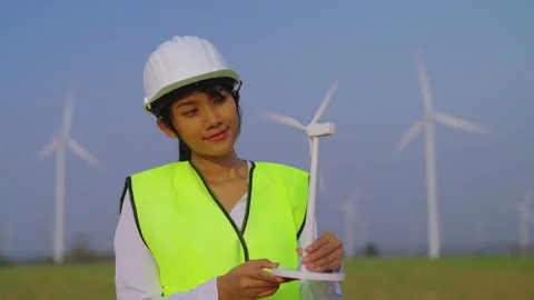 Portrait of female engineer looking to wind turbine. Stock Footage 235552564