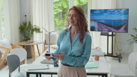 Portrait of Female Engineer Posing with Wind Turbine Model at Green Office Stock Footage 301294307